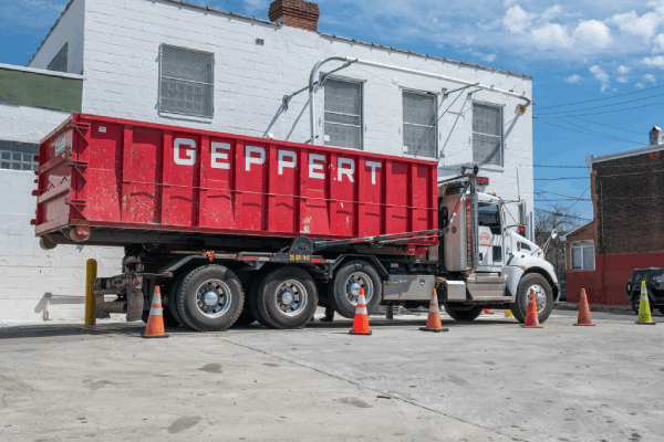 Truck unloading a dumpster